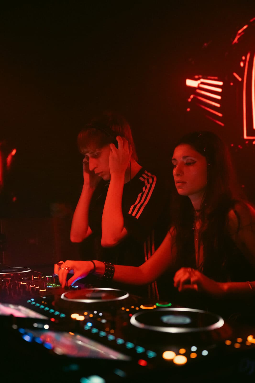 KAIF de perfil con auriculares, luz roja